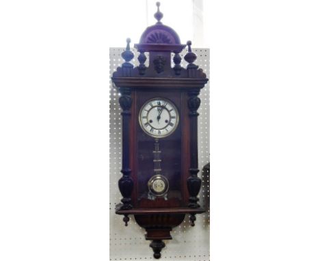 A late 19thC German oak and ebonised wall clock, enamel dial bearing Roman numerals, eight day movement with coil strike, the