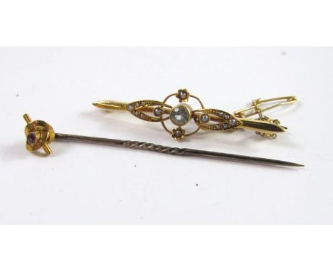 A 15ct gold aquamarine and seed pearl bar brooch, 2.5g, and a yellow metal and gem set tie pin, boxed.