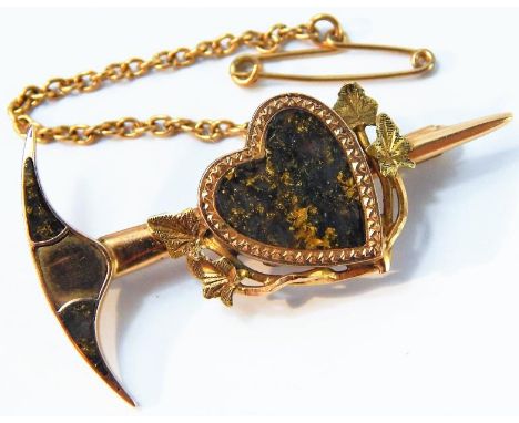 A yellow metal and veined gold brooch of heart and a prospector's pick axe form, with safety chain as fitted, 5.9g total weig