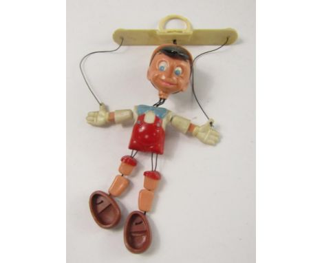 A Walt Disney Productions puppet, modelled as Pinocchio, made in Hong Kong, 19cm long.