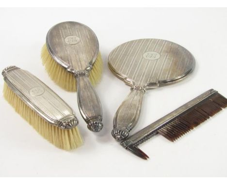 A Victorian silver four piece dressing table set, with engine turned decoration, reserve monogram, comprising hand mirror, ha