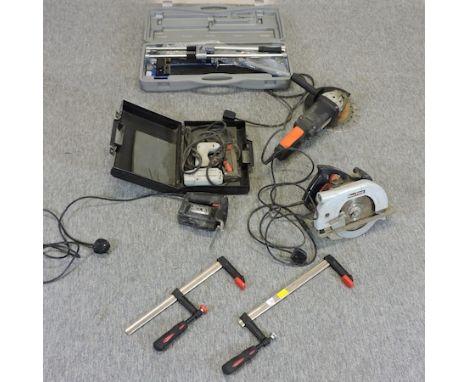A collection of power and other tools, to include an angle grinder, tile cutter, disc saw, jigsaw and others