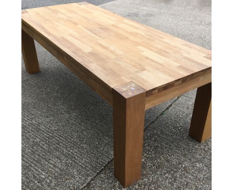 A large light oak dining table, together with a set of six cream upholstered dining chairs, 235 x 100cm
