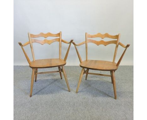 A pair of Ercol light elm cowhorn shaped side chairs