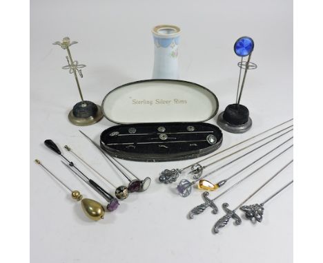 A collection of hat pins, to include an enamel pin with a swivel head, together with an early 20th century set of hat pins an
