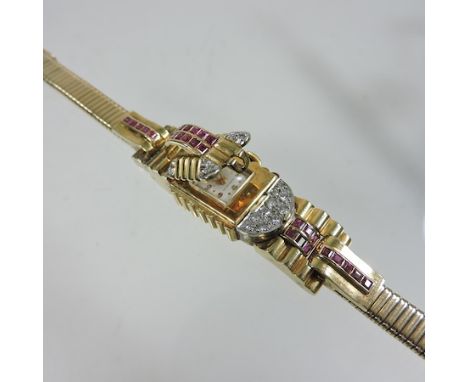 An unmarked Art Deco style gold, ruby and diamond set ladies cocktail wristwatch, with a hinged front, on a flexible strap, b