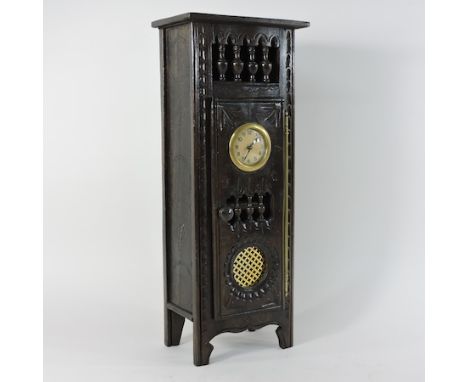 An early 20th century oak miniature cabinet, inset with a clock, 45cm high