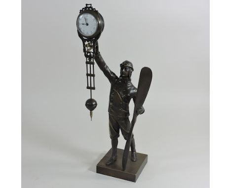 A figural mystery clock, in the form of an aviator, 35cm high