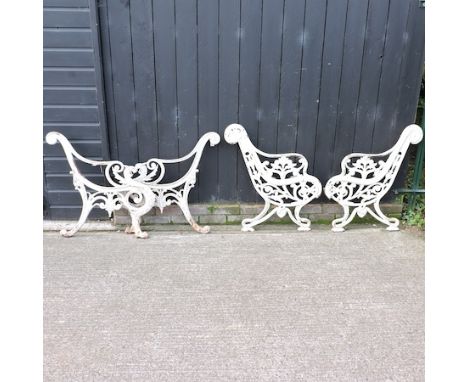 A pair of ornate 19th century painted cast iron bench ends, together with another pair