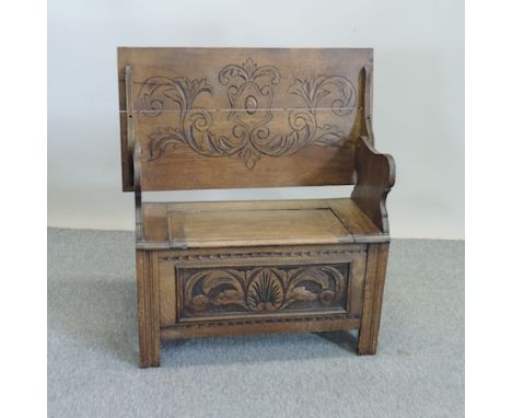 A 1920's carved oak monk's bench, 90cm
