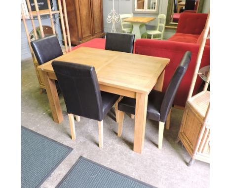 A light oak extending dining table, with an additional leaf, 165 x 80cm overall, together with a set of four high back brown 