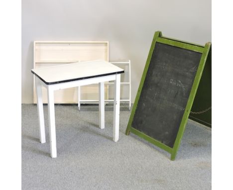 A 1950's enamel top kitchen table, 76cm, together with a white painted shelf, another and a folding blackboard