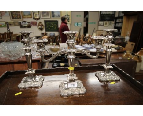 A plated three light candelabra and a pair of matching candlesticks