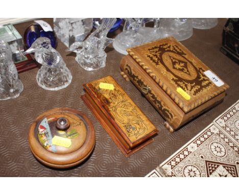 A musical trinket box together with one other box decorated with dragons and a souvenir jar and cover