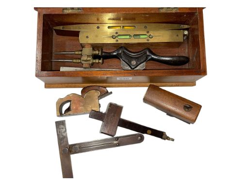 Small mahogany box with vintage planes, spirit levels and gauges.