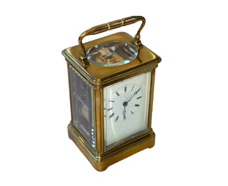 Gilt brass carriage clock with striking movement, 14cm.