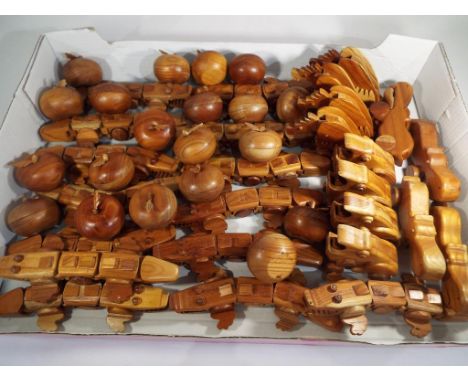 A quantity of carved wooden puzzle trinket boxes and novelty toys to include fourteen aligators, four frogs, four hippo's, fo