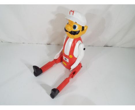 A good quality carved wooden hand-painted shelf puppet depicting Mario. Estimate £20 - £30