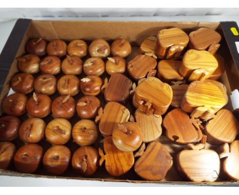 A quantity of approx twenty seven carved wooden trinket boxes in the form of apples and a further twenty two carved wooden ap