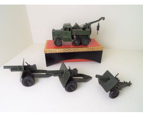 Four Military diecast models comprising a Dinky Recovery Tractor # 661 (fully functional), two Britains Field Guns and a Lone