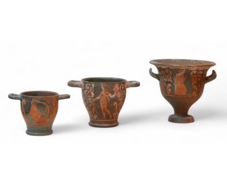 Three Attic style red figure terracotta vases, comprising a bell krater vase, 22 by 19.5cm high overall, and two skyphoi. (3)