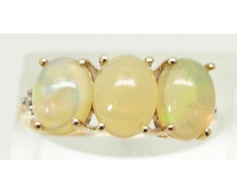 A 9ct gold ring set with three oval Ethiopian opal cabochons and diamonds, size R, 2.2g