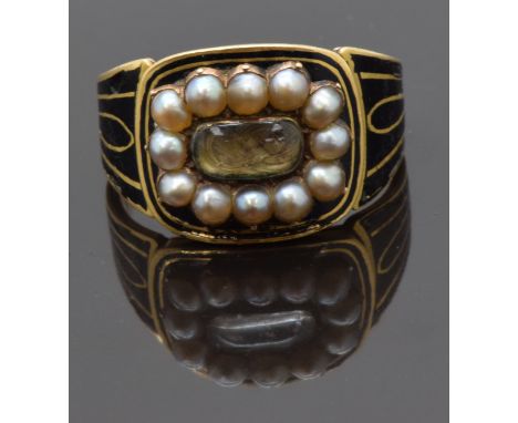 Georgian mourning ring set with plaited hair to the centre surrounded by seed pearls and decorated with black enamel to the b