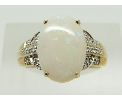 A 9ct gold ring set with an oval opal and diamonds, 2.9g, size N