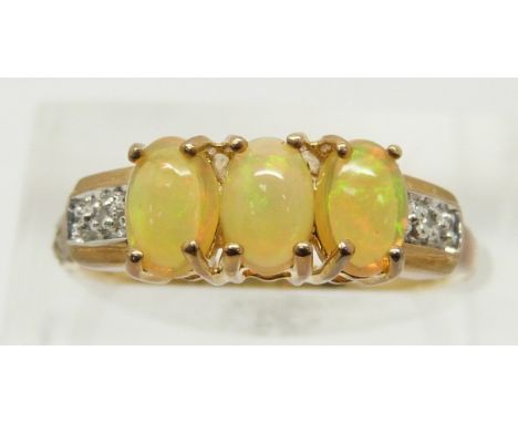 A 9ct gold ring set with three opal cabochons and diamonds, 2.3g, size N