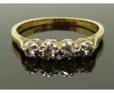 An 18ct gold ring set with four diamonds in a platinum setting, size R/S, 3.00g&nbsp;