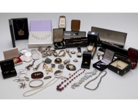 A collection of costume jewellery including silver watch, Miracle brooch, beads, coins, necklace made of watch parts, lacquer