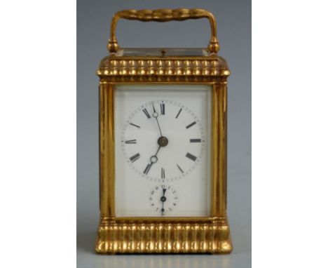 A 19thC gilt brass carriage clock with moulded decoration to corniche style case, the half hourly repeater and alarm movement