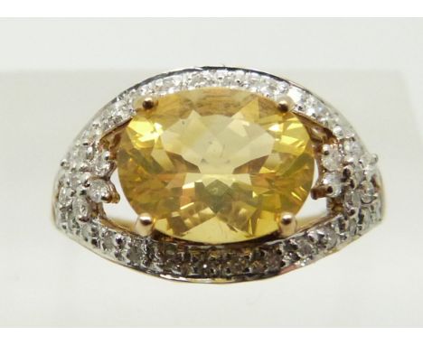 A 9ct gold ring set with an oval cut fire opal and diamonds, 2.8g, size N