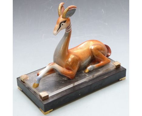 Art Deco style ceramic gazelle raised on a stepped base, marked to rear possibly Mangani, height 31cm
