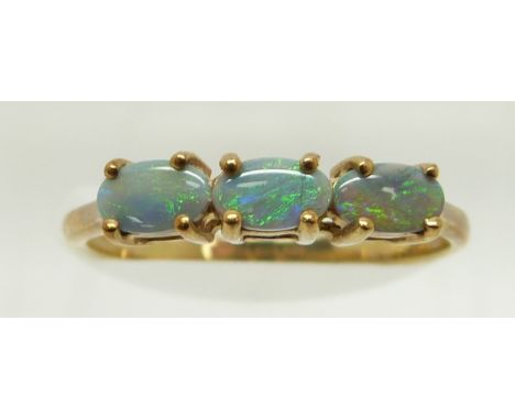 A 9ct gold ring set with three oval black opal cabochons, 1.5g, size N&nbsp;