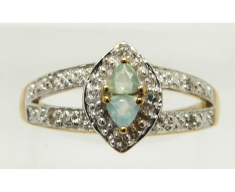 A 9ct gold ring set with two trilliant cut Paraiba opals and topaz, 2.8g, size N