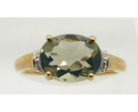 A 9ct gold ring set with a green fire opal and diamonds, 1.9g, size N