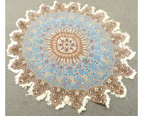 Turkish rosette shaped rug with light blue ground and floral field design, diameter 148cm
