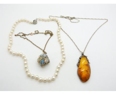 A strand of cultured pearls, a pressed amber pendant, and a 9ct gold pendant filled with opal boulder