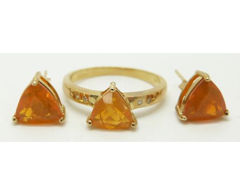 A 9ct gold ring set with a trilliant cut fire opal and diamonds and a pair of 9ct gold earrings set with a trilliant cut fire