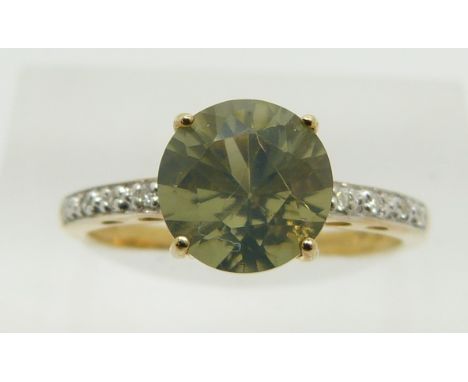 A 9ct gold ring set with a round cut green fire opal and diamonds, 2.2g, size N