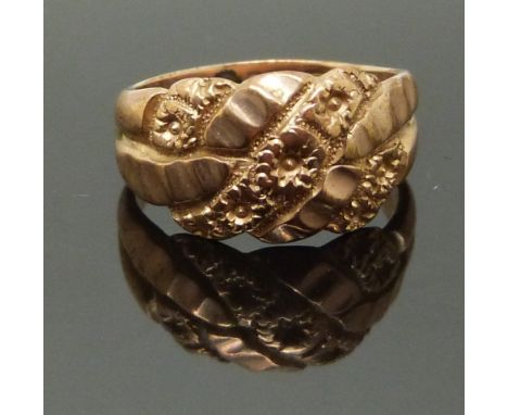 A 9ct rose gold keeper ring with floral decoration, size J, 4.17g&nbsp;