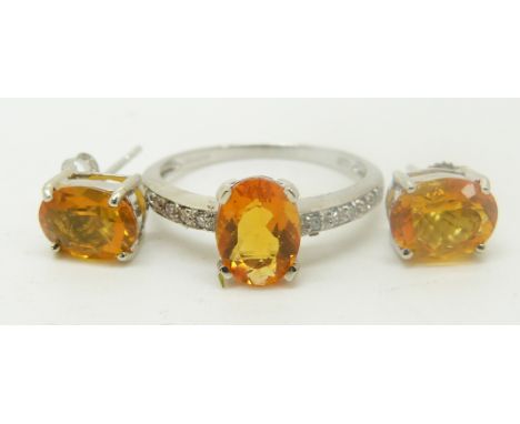 A 9ct white gold ring set with an oval cut fire opal and diamonds and a pair of 9ct gold earrings set with a fire opal, 3.4g,