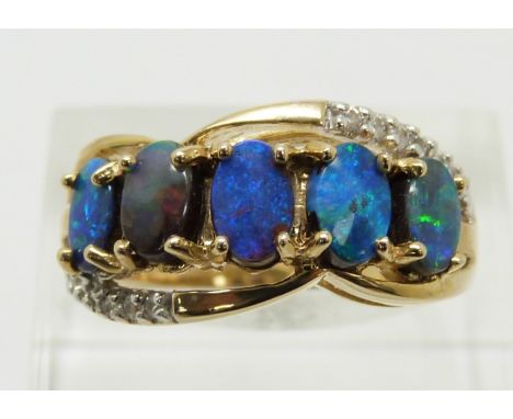 A 9ct gold ring set with five boulder opals and zircons, 4.7g, size N