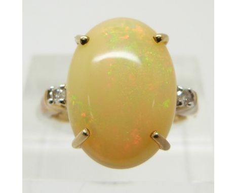 A 9ct gold ring set with a large opal cabochon and diamonds, 3.6g, size O