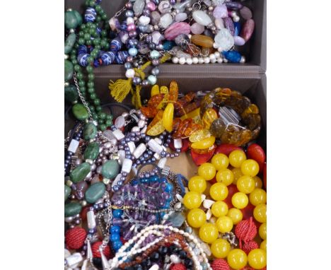 A large collection of beaded necklaces including nephrite jade, pearl, pressed amber, quartz, glass, etc&nbsp;