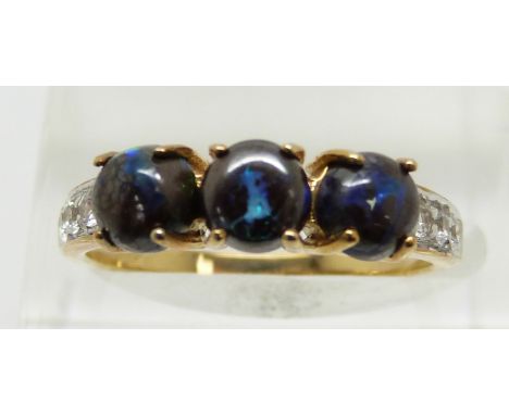 A 9ct gold ring set with three round boulder opal cabochons and white sapphires, 2.3g, size N