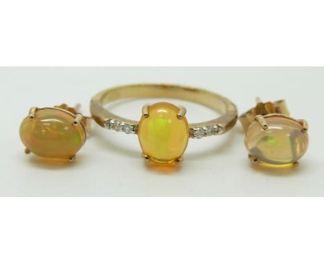 A 9ct gold ring set with an oval opal cabochon and diamonds (size N) with a pair of similar earrings&nbsp;