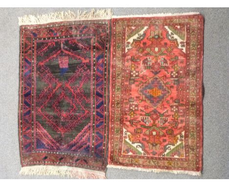 A Persian geometric rug with brown ground, canavar ayagi pattern to central field and bereket motifs to border, 130 x 85cm an