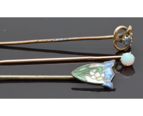 Two 9ct gold stick pins, one set with a sapphire and the other an opal together with a silver stick pin set with enamel&nbsp;